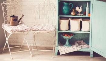 Sideboard and chairs are on a brick background photo