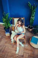 woman with book sitting in chair photo