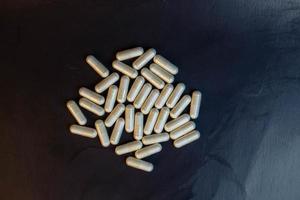 pills on black background photo