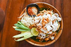 Fried noodle shrimp prawn and crab meat, Thai food noodles stir fry vegetables and rice vermicelli with egg cooked Asian food photo