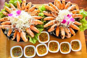 Seafood buffet Thai food, Grilled shrimp prawn with fresh vegetable and seafood sauce shrimps grilled serve on tray