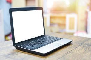 blank screen laptop on workspace desk wooden photo