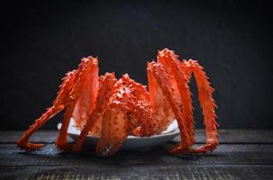 cangrejo rey cocido comida al vapor en platos de marisco con fondo oscuro - cangrejo rojo de alaska hokkaido foto