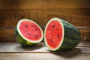 Watermelon slice half summer fruit - Fresh red watermelon on wooden background photo