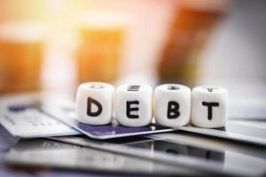 Debt credit card and money coin stack Increased liabilities from exemption debt consolidation concept
