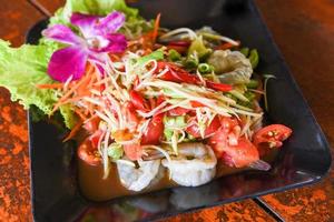 Green papaya salad with shrimp prawn Thai food, spicy salad herbs photo