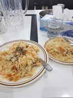 Veg biryani or pulav served in a two plates photo