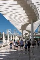 Malaga, Spain, 2016. People Walking under the Modern Pergola in the Harbour Area