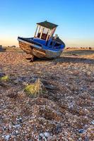 DUNGENESS, KENT, UK, 2008. Derelict Fishing Boat on the Beach photo