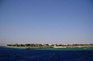 big hotel area with jetty and palm trees photo