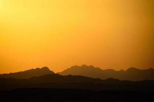 different mountains and orange sky photo