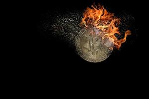single valueable burning decomposes and dissolves bitcoin from crypto currency with black photo