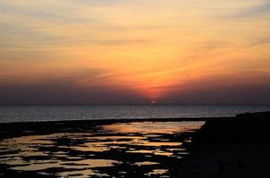 sunrise at sea with reflections photo