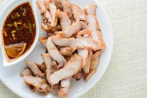 Grilled Pork with Thai Spicy Sauce. it can be served as an appetizer. photo