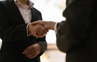 businesswomen Handshaking,happy with work,the woman she is enjoying with her workmate,Handshake Gesturing People Connection Deal Concept photo