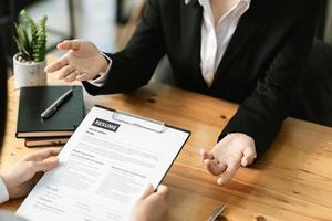 woman submit resume to employer to review job application. The concept presents the ability for the company to agree with the position of the job.