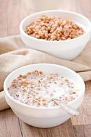 Buckwheat porridge in a bowl on a wooden table photo