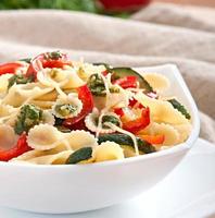 pasta with zucchini and sweet peppers with basil-garlic dressing photo