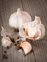 garlic and pepper on a wooden background photo