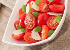 tomato cherry salad with basil, black pepper and onion photo