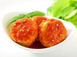 meatballs in tomato sauce, decorated with leaves of basil photo