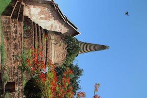 Ancient stupa and church made from red brick and light blue sky. photo