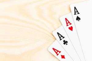 Four aces on wooden background