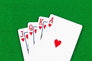 Royal flush poker playing cards on green felt background photo