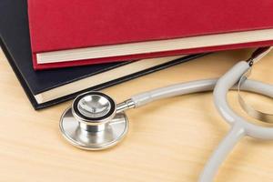 Stethoscope and textbook concept for medical education photo