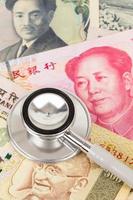 Stethoscope on asian banknote concept financial health check photo