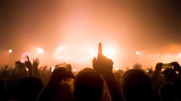 Party People Rock Concert. Crowd Happy and Joyful and Applauding or Clapping. Celebration party festival happiness. Blurry night club. Concert Show with DJ Music festival EDM on Stage photo