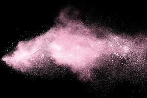 Pink dust particles splash on black background. photo