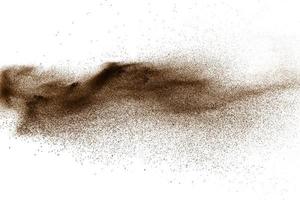 Deep Brown particles splattered on white background. Brown dust splash. photo