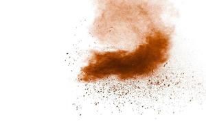 Brown dust splashing.Brown particles splattered on white background. photo