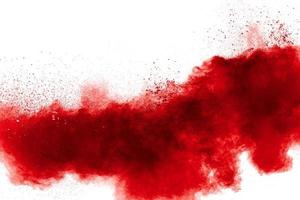 Red powder explosion on white background. Freeze motion of red dust particles splash. photo