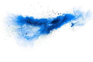 Blue color powder explosion cloud on white background.Blue dust particles splash on background. photo