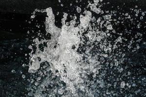 Water Splash on black background.Stylish water splash. Isolated on black background. photo