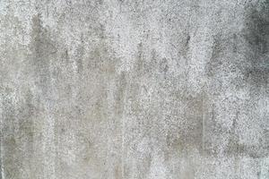Closeup pale color and peeling of painted white cement wall texture background. photo