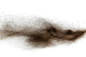 Deep Brown particles splattered on white background. Brown dust splash. photo