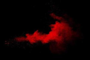 Abstract red powder on black background. Red color clouds. photo