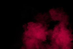Abstract red powder dust explosion on black background. photo
