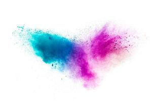 Abstract multicolored powder splash on white background.Freeze motion of color powder exploding. photo