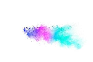 Multicolored particles explosion on white background. Colorful dust splatter. photo