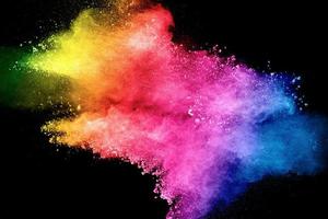 Pastel color dust particle splashing.Colorful powder explosion on blackackground. photo