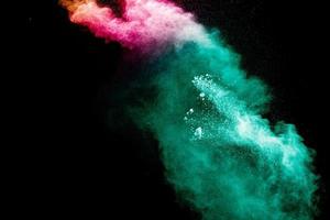 Abstract multi color powder explosion on black background. photo