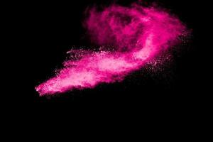 Pink powder explosion on black background. photo