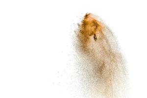 Brown dry river sand explosion isolated on white background. Abstract sand splashing. photo