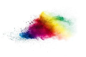 Multicolored particles explosion on white background. Colorful dust splattered. photo