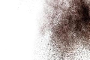 Brown powder dust cloud.Brown particles splattered on white background. photo