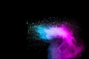Explosion of blue pink colored powder isolated on black background.Pink blue dust splash. photo